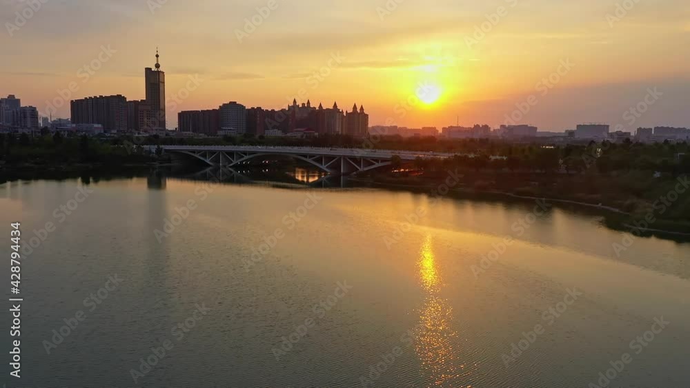 Aerial panoramic view, a bridge in a Chinese city and residential area at sunset