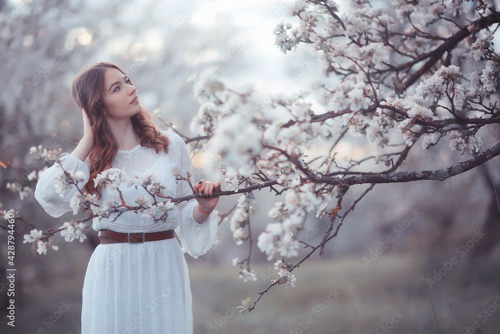 springtime fashion portrait of a young girl in a blooming cherry garden, tenderness of the morning springtime fashion portrait of a young girl in a blooming cherry garden, tenderness of the morning