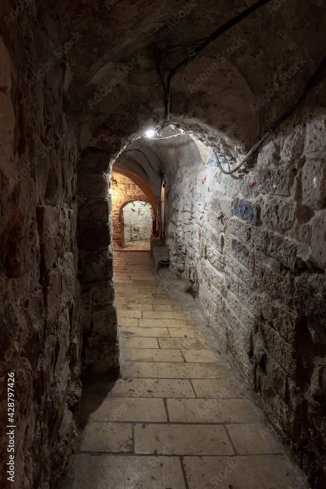 Tunnel  passage under residential buildings in the Muslim quarter near the exit from the Temple Mount - Chain Gate, in the old city of Jerusalem, in Israel