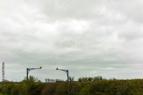 average speed camera on UK Motorway over cloudy sky