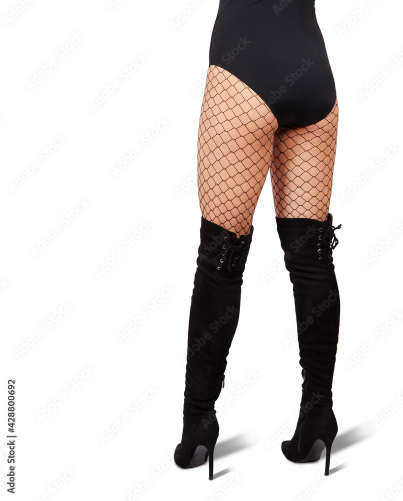 slender female legs in mesh tights and black boots slender female legs in mesh tights and black boots
