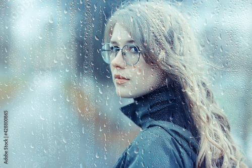 seasonal autumn portrait, sad girl with umbrella, november seasonal virus immunity on a walk