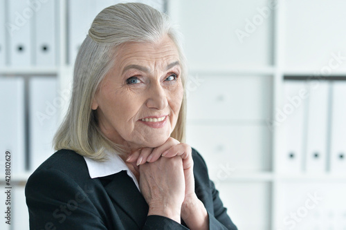 Emotional old businesswoman in office