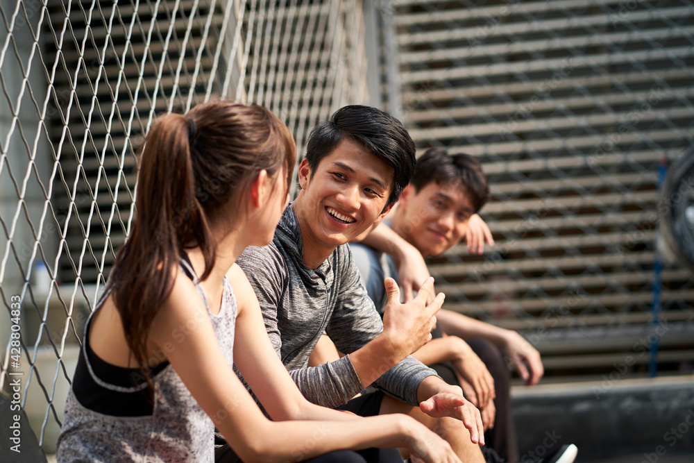 young asian people resting after outdoor sport activities