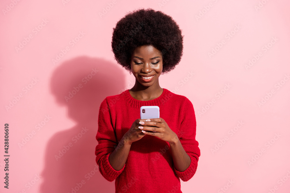 Portrait of attractive cheerful focused girl using device app 5g comment isolated over pink pastel color background Portrait of attractive cheerful focused girl using device app 5g comment isolated over pink pastel color background
