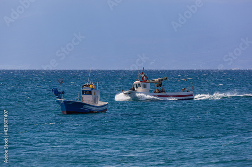 Fishing boats comes back to the coast, Almeria, Spain.