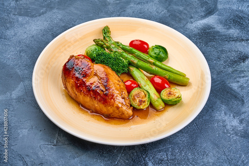 Roasted chicken breast with vegetables. Healthy food, on grunge background. High resolution image