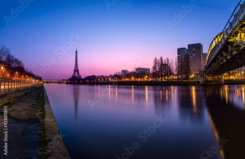 Cityscape of Paris with the Eiffel tower during the Blue hour before sunrise. The Rouelle bridge is on the right.