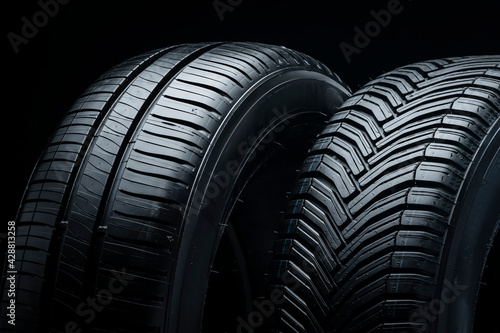 a pair of summer tires, side view, close-up on a black background