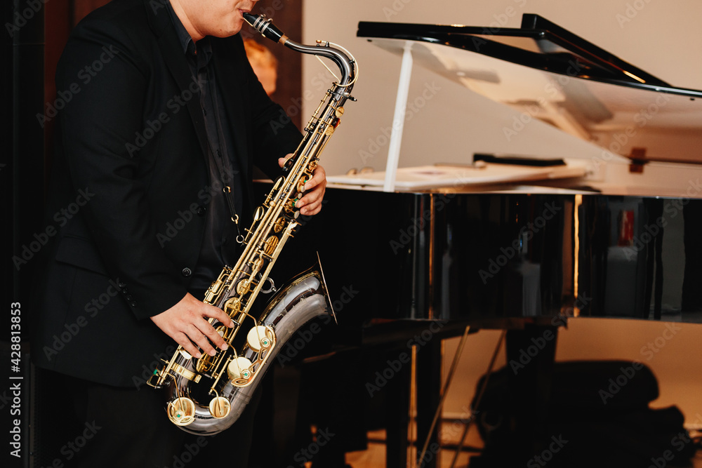 Fototapeta premium Saxophone player Saxophonist playing jazz music instrument Jazz musician