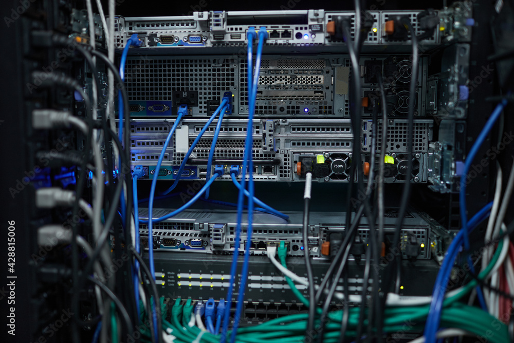 Background close up of server cabinet with cables and wires in data center, supercomputer concept, copy space