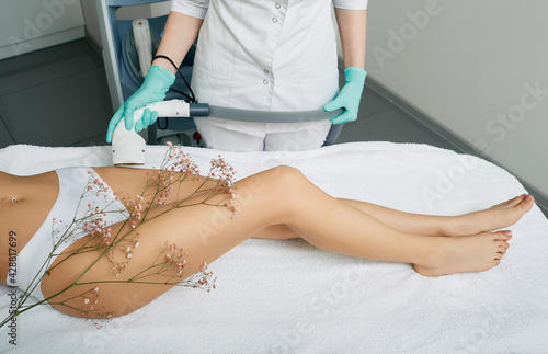 Bikini zone laser hair removal for a woman using a medical laser. Woman receiving laser epilation on bikini zone at a beauty clinic