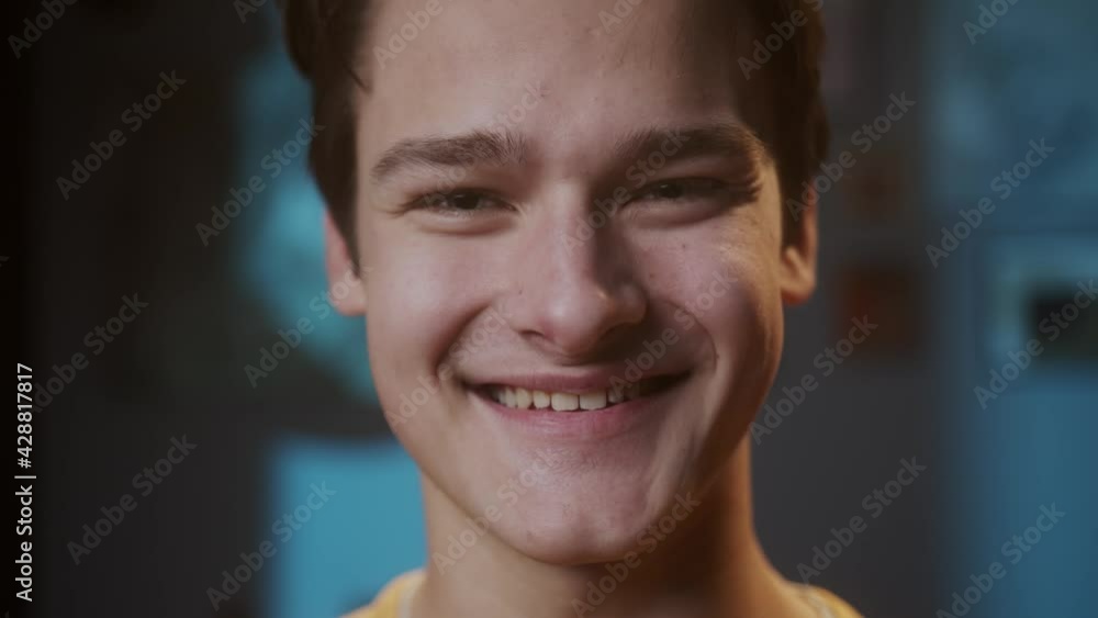 Portrait of young happy man with light blue eyes, looking in camera smiling widely. Close-up of male face cheerful student. Portrait of young happy man with light blue eyes, looking in camera smiling widely. Close-up of male face cheerful student.