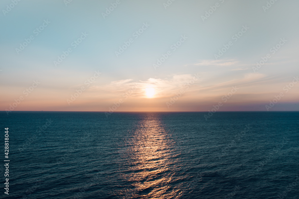 Naklejka premium a sunset over the blue sea
