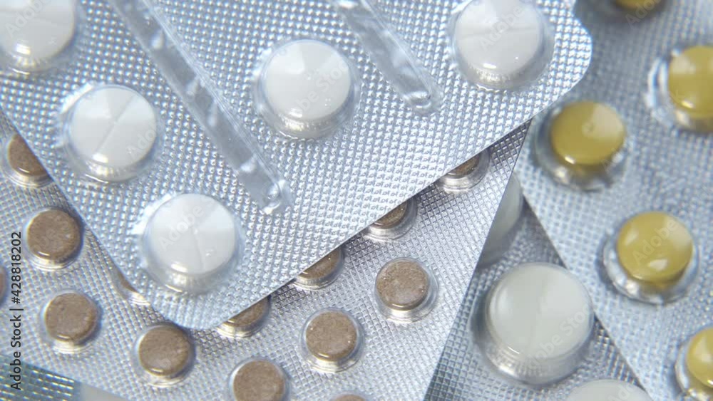 Overall view of pharmaceutical tablets and capsules in packages in assortment. Tablets in a blister. Selective Focus Overall view of pharmaceutical tablets and capsules in packages in assortment. Tablets in a blister. Selective Focus
