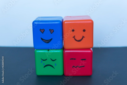 Foto Different emotions concept, funny faces drawn on cubes.