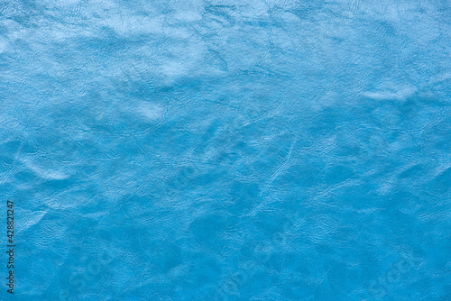 blue artificial leather texture for background © kwanchaift