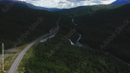 Aerial of Overcast Hills, Forest Valley Road, and Rovijokfossen Waterfall, Finland photo