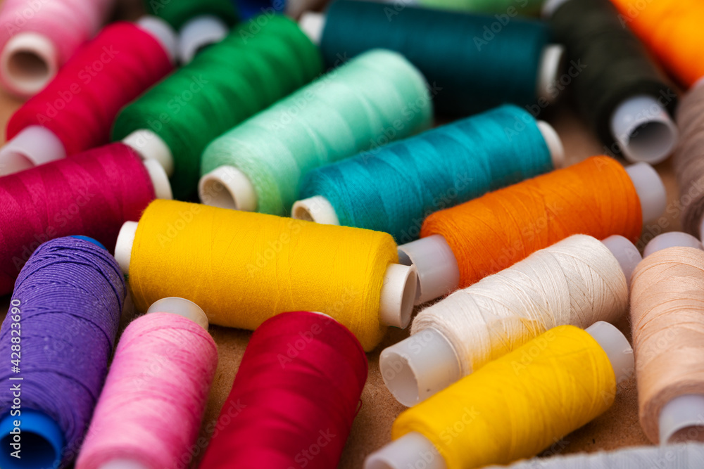 Many colored spools of threads as a background Many colored spools of threads as a background