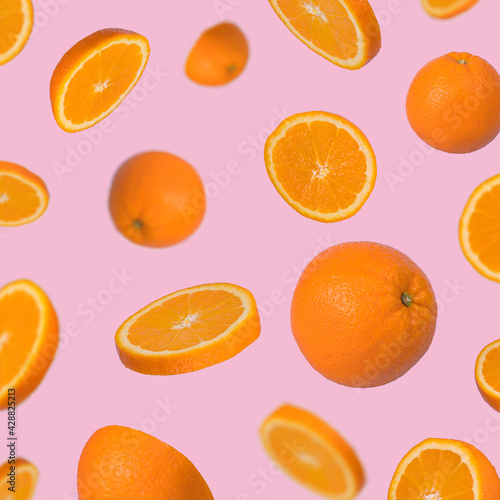 Minimal idea with fresh orange sliced on pastel pink background, minimal fruit concept.