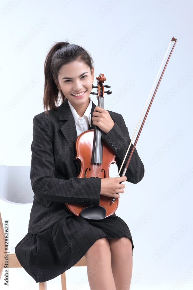 In violin practice class,two beautiful woman hold wooden violin.teach and practice playing violin together to prepare for the concert. In violin practice class,two beautiful woman hold wooden violin.teach and practice playing violin together to prepare for the concert.