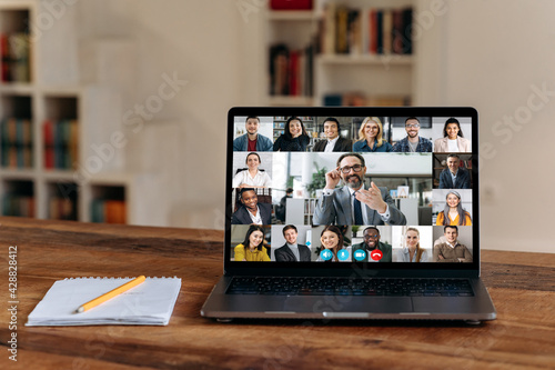 Virtual meeting.View at laptop screen with group of business people of different nationalities gathered from different parts of the world for communication and discussion business issues by video call