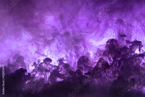 Abstract background picture with purple ink dissolving in water