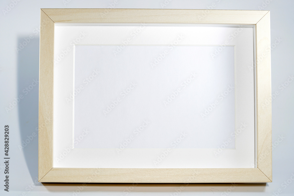 Picture frame with wooden frame photographed frontally in the studio with shadows Picture frame with wooden frame photographed frontally in the studio with shadows