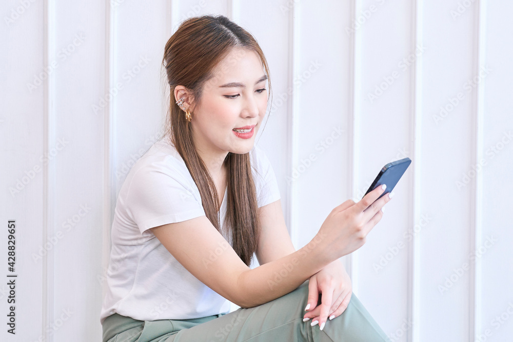 Attractive beautiful girl use phone on white background Attractive beautiful girl use phone on white background
