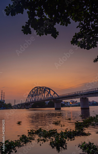 Beautiful sunset on Binh Loi Bridge new and old by night in the rush hour, Ho Chi Minh City, Vietnam.