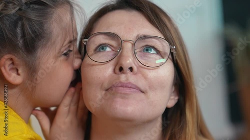 Wallpaper Mural kid whisper a secret. daughter whispers in mom ear confidential news rumors. happy family kid dream concept together. daughter close-up whispers in parent ear. happy family mom and daughter fun Torontodigital.ca