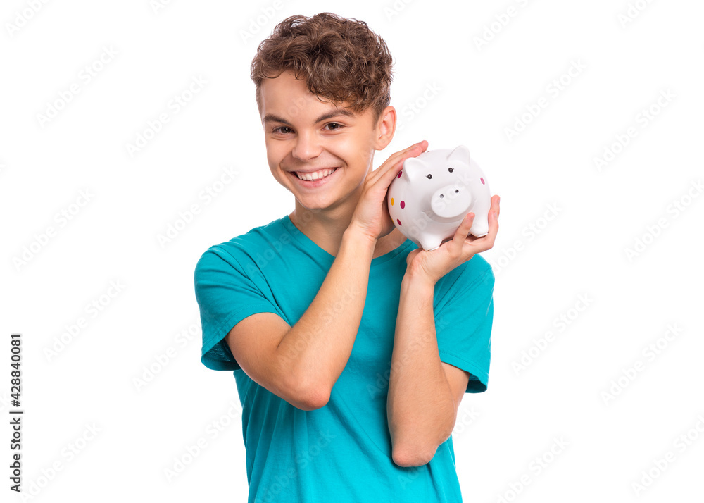 Portrait of teen boy holding Piggy Bank. Cute caucasian young teenager isolated on white background. Saving Money concept. Crazy funny child about to break his piggybank Portrait of teen boy holding Piggy Bank. Cute caucasian young teenager isolated on white background. Saving Money concept. Crazy funny child about to break his piggybank