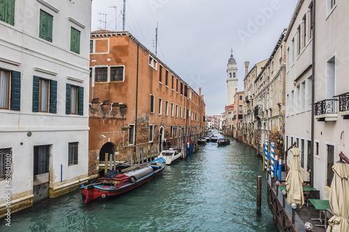 View of Rio dei Greci (Greeks' Canal) with the leaning bell tower of the orthodox church of San Giorgio dei Greci (1592) in the background. Venice, Veneto, Italy. photo