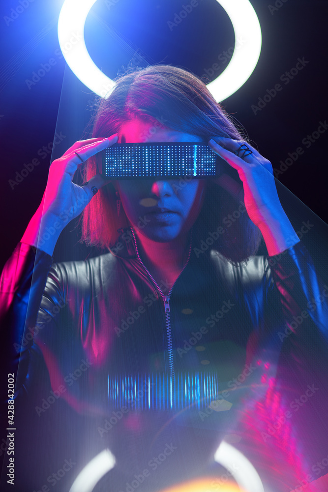 Cyberpunk style portrait of beautiful young woman in futuristic costume.