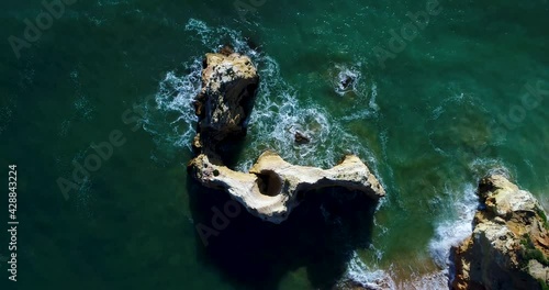 Scenic revealing aerial view of the coastline near the Vau Beach (Praia do Vau) in Portimao, Algarve, Portugal