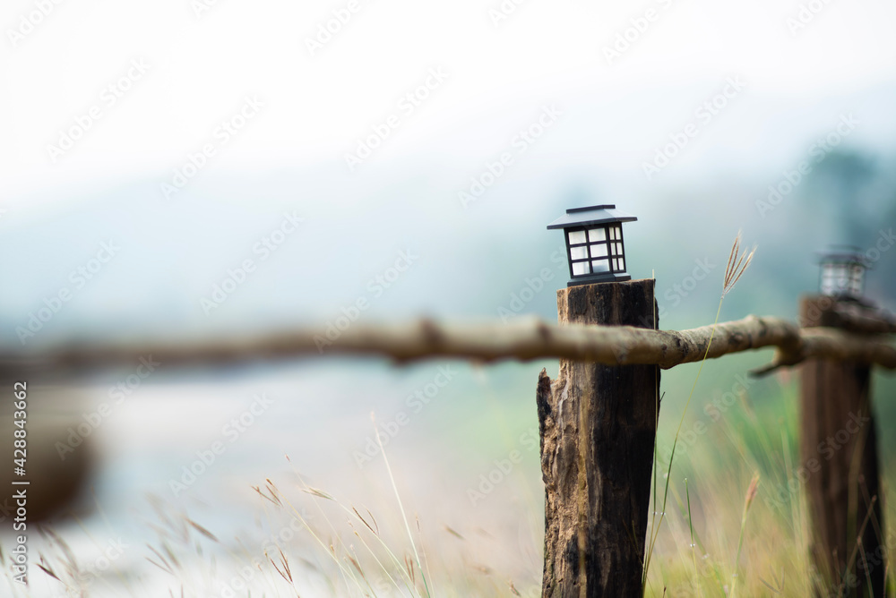 Tiny lamp on the wooden rail