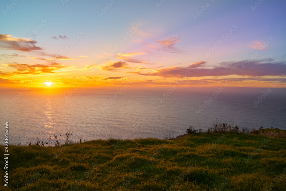 sunset over the sea from a cliff