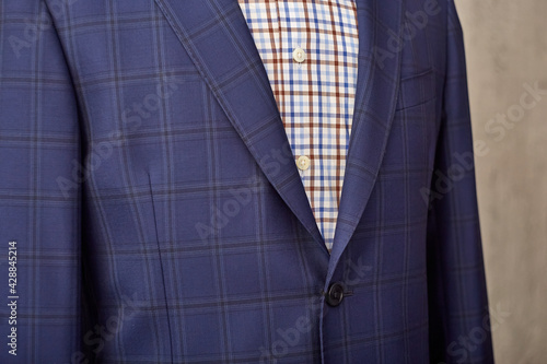 Men's casual checkered tweed coat and shirt lapel closeup