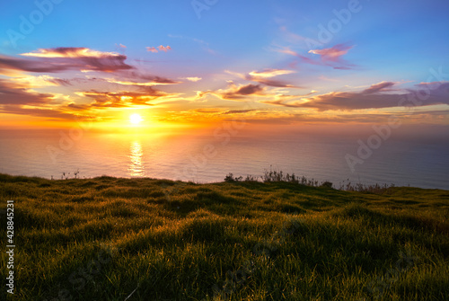 sunset over the sea from the cliff