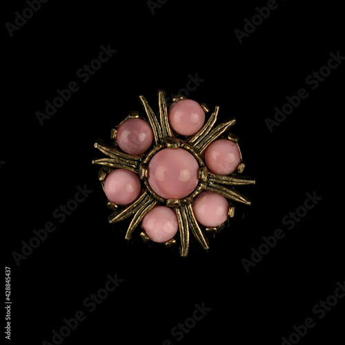Round antique brooch with a flower shape. Vintage brooch in the shape of a flower