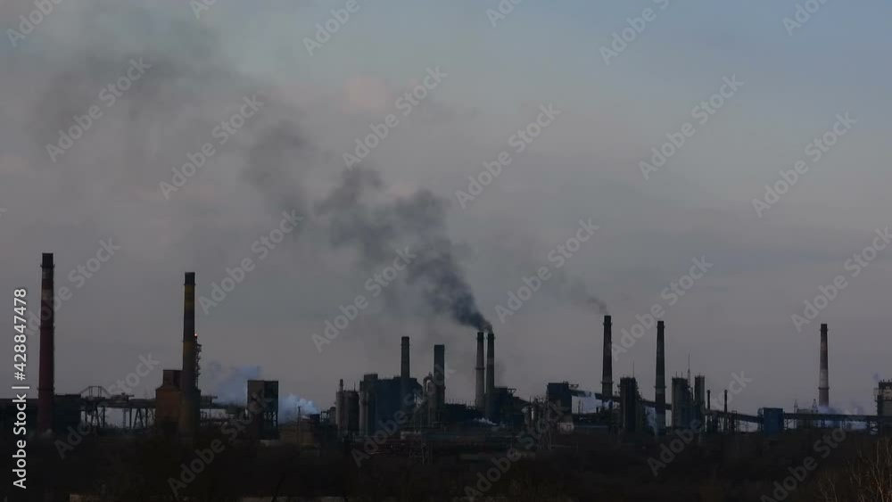 Silhouettes of an industrial factory time lapse. Fuming chimneys. Air pollution concept background. Silhouettes of an industrial factory time lapse. Fuming chimneys. Air pollution concept background.
