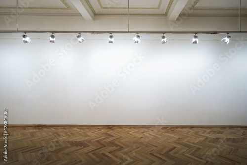 Interior of a empty white wall with spot lights at art gallery photo