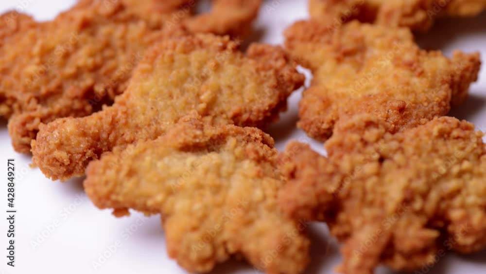 macro closeup of kid's meal dinossaur chicken nuggets snacks rotating macro closeup of kid's meal dinossaur chicken nuggets snacks rotating