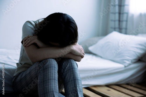 Asian woman is introverted alone in her bedroom, She is lonely and has stress, Depression. © Basicdog