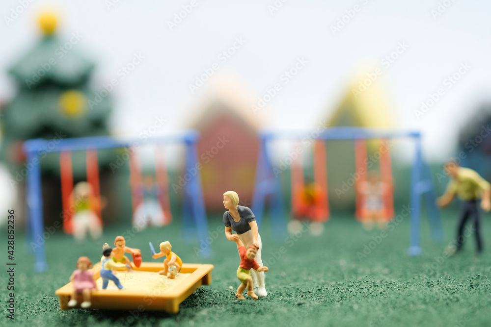 Fototapeta premium Miniature people : Children are enjoy playing together at the playground with many plaything use as children day concept.