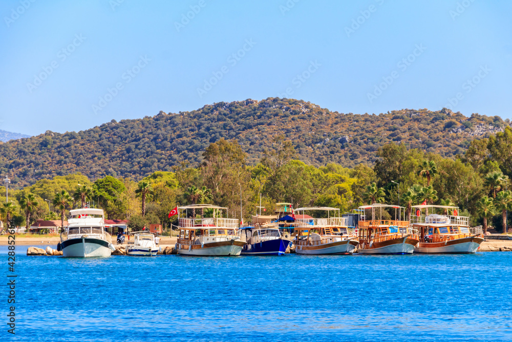 Port with tourist boats on the Mediterranean sea coast in Turkey