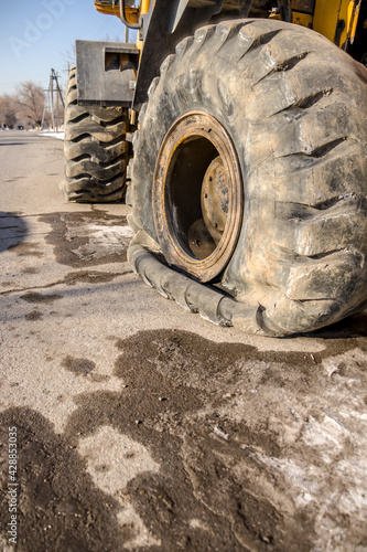 Flat tire of a large tractor close-up