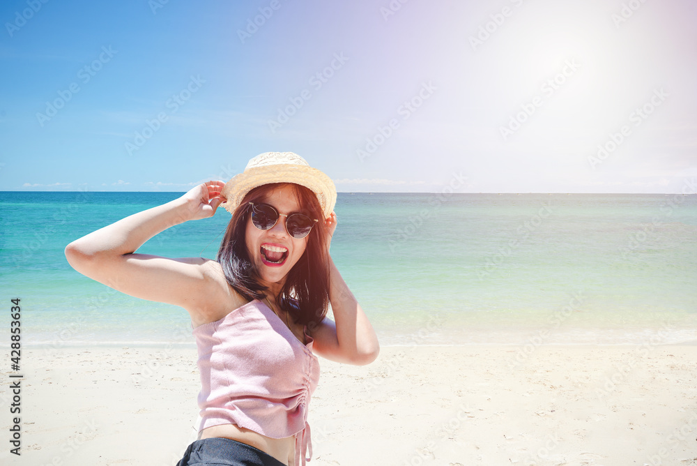 Face of young woman wearing pink tank hold straw hat wearing sunglasses. Happy woman smiling during summer vacation at sea. Beautiful lady relaxing at beach. fresh sky. Holiday, tropical, comfortable Face of young woman wearing pink tank hold straw hat wearing sunglasses. Happy woman smiling during summer vacation at sea. Beautiful lady relaxing at beach. fresh sky. Holiday, tropical, comfortable