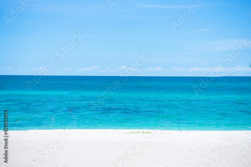 Beautiful wide of seascape with blue sky at daylight. Sand of beach smooth Sea.