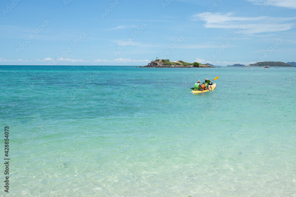 Family backward view playing Kayak or canoeing in the sea. Family People traveler kayaking in the ocean. Holiday and outdoor concept. Fresh water. Family time concept. Clear nature. Copy space.